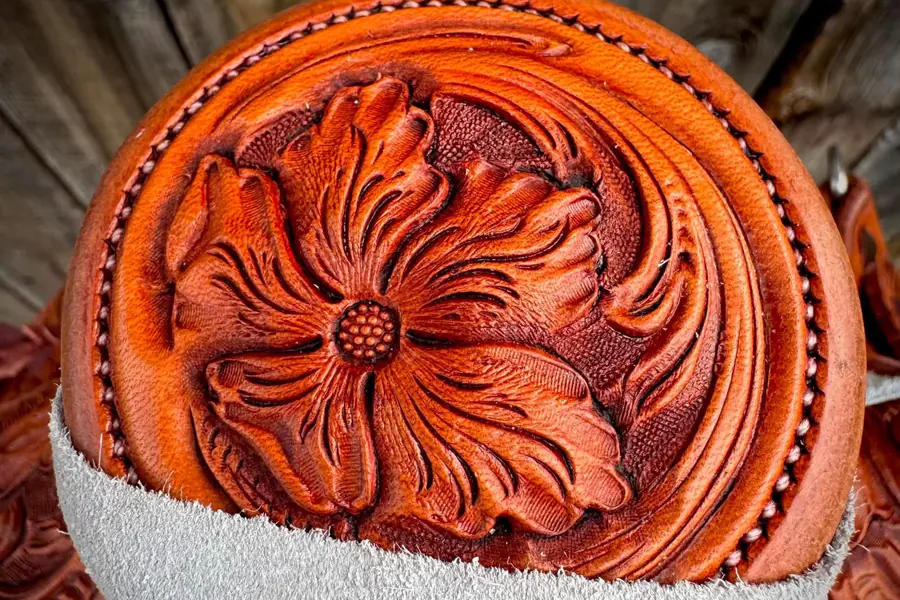 A single large carved flower on a saddle horn cap
